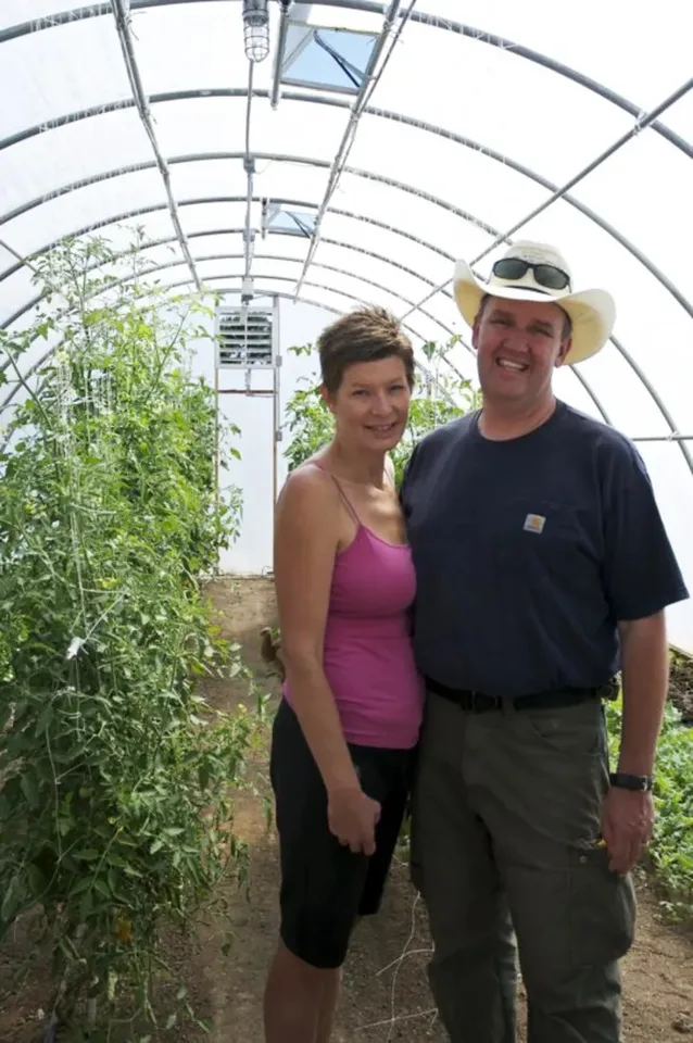 Craig and Kellie standing in their greenhouse in 2014